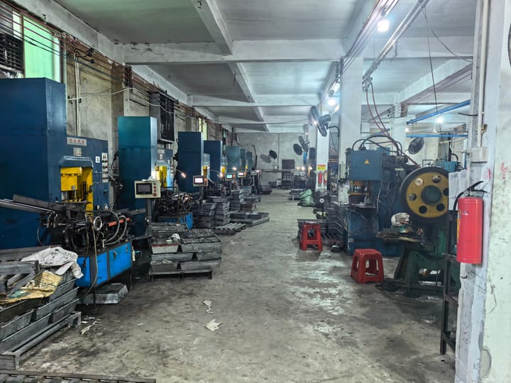 Bright stamping bay with rows of machines