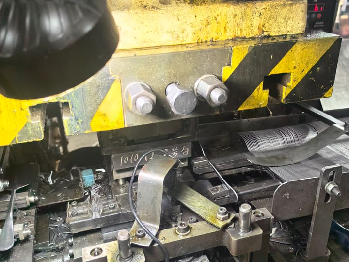 Progressive die and feed mechanism on a stamping press